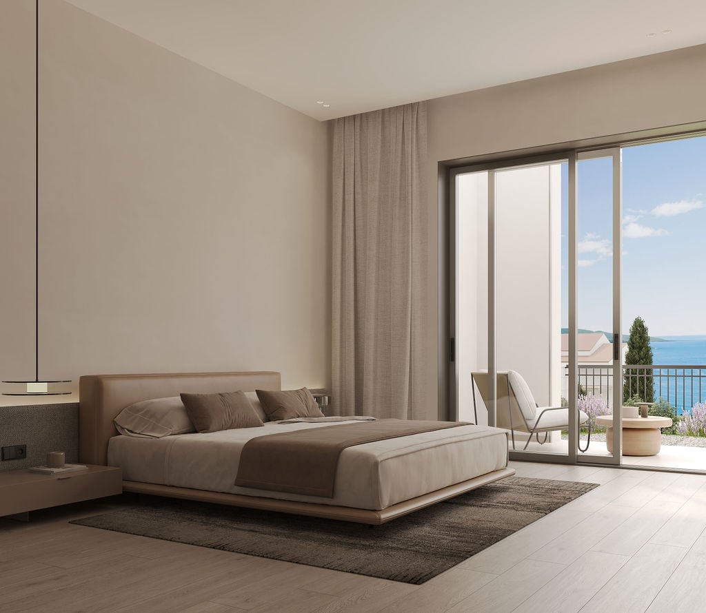 Modern bedroom in the Luštica residential complex, Montenegro: double bed, panoramic windows, and a terrace with a sea view.