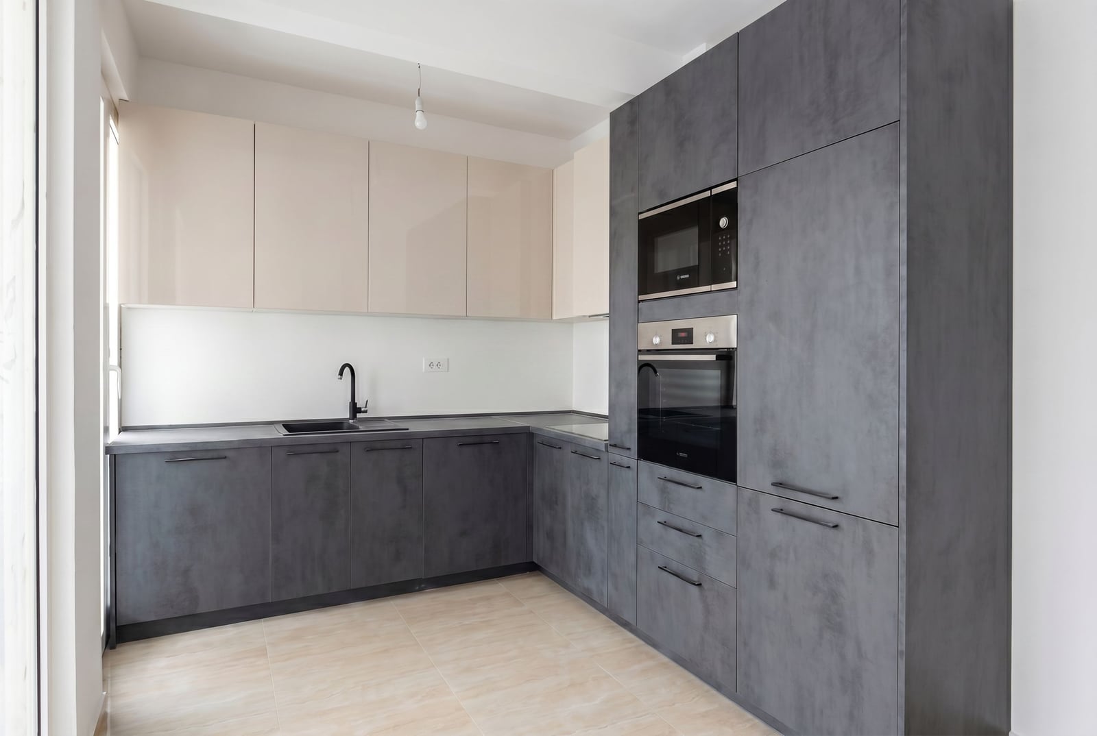 Modern kitchen in an apartment in Herceg Novi, Montenegro: gray cabinet fronts, built-in appliances, and light wall finishes.