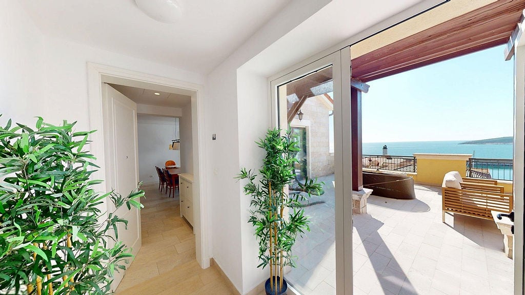 Bright living room with access to a terrace and sea view in the Luštica residential complex, Montenegro.