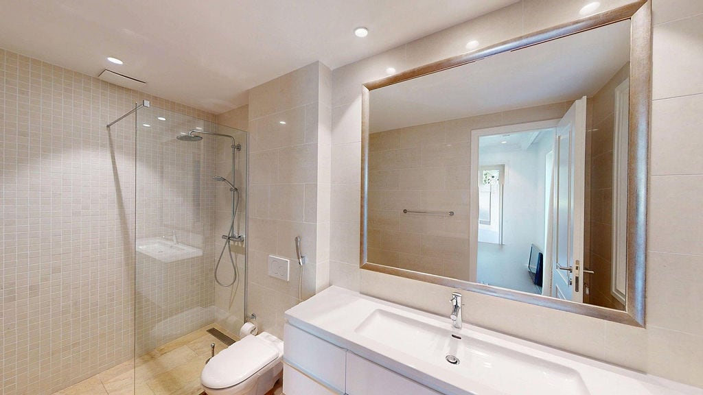 Modern bathroom with a shower cabin and light finishes in a residential complex, Luštica, Montenegro.