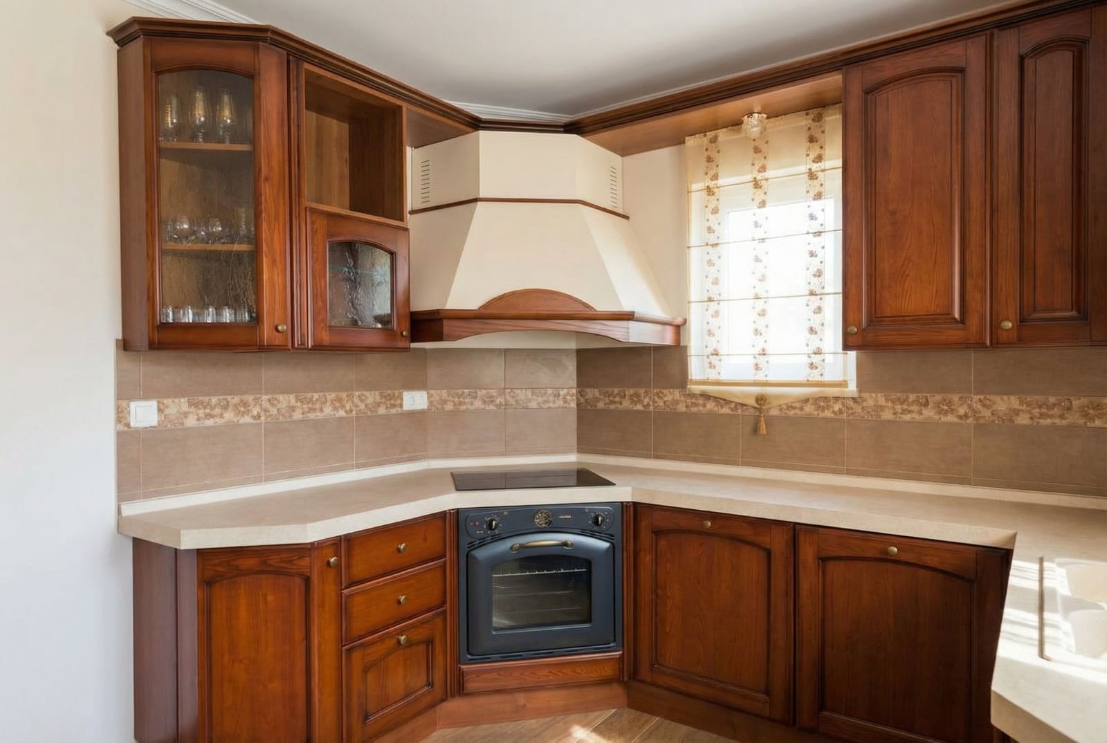 Corner kitchen made of dark wood with built-in appliances in a house, Herceg Novi, Montenegro. Light countertop and tiles.