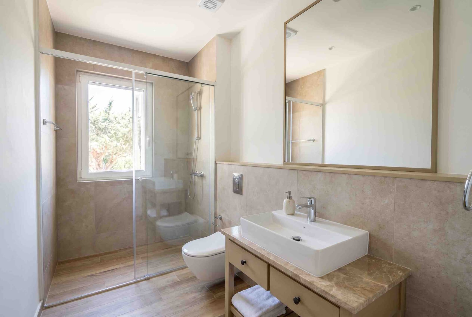 Modern bathroom with a shower cabin and stone countertop in an apartment, Luštica, Montenegro.