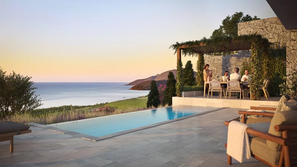 Villa terrace in Luštica, Montenegro: infinity pool, dining area under a pergola, and panoramic sea view.