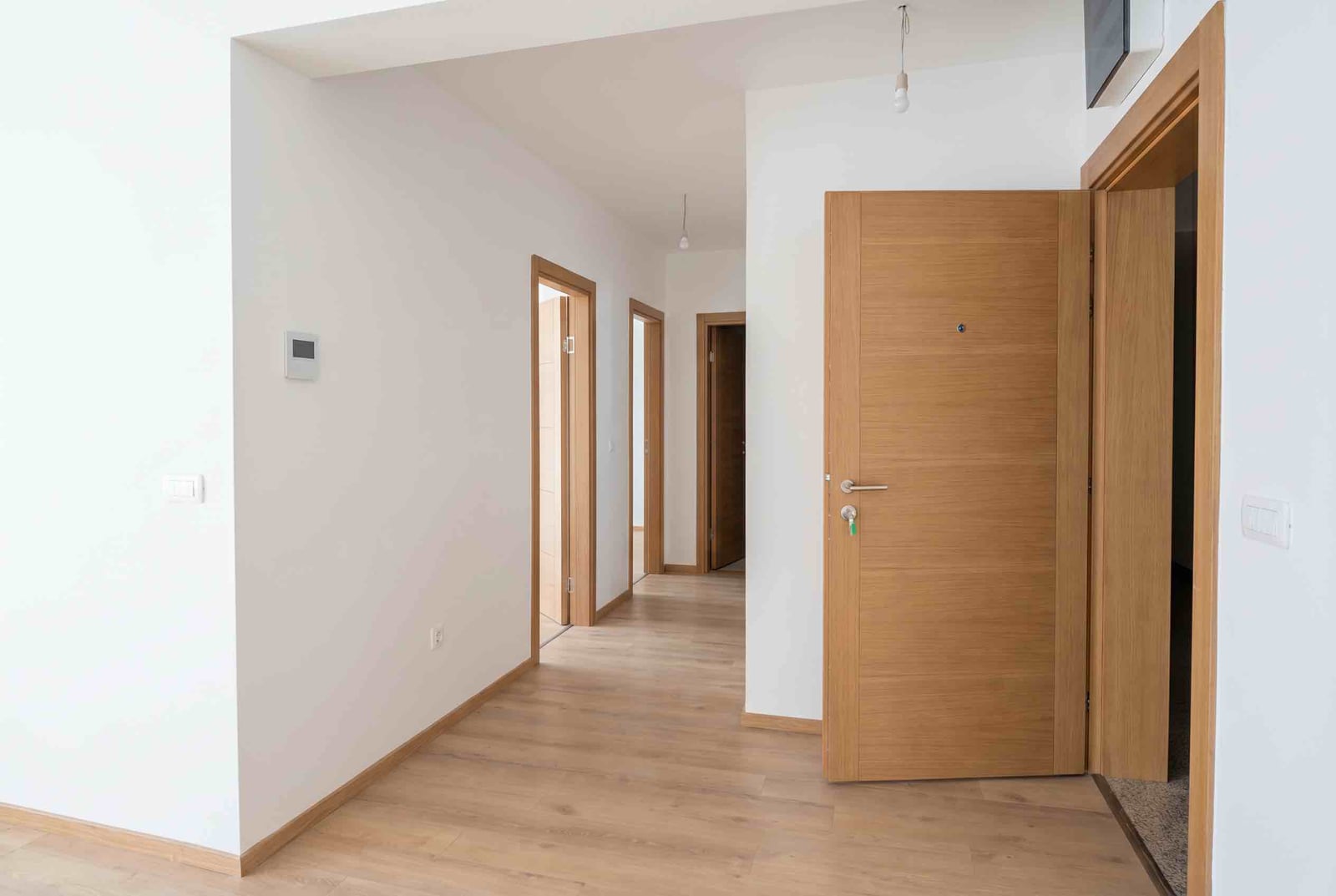 Bright hallway in an apartment, Pržno, Montenegro: wood-effect laminate flooring, interior doors, and modern wall finishes.