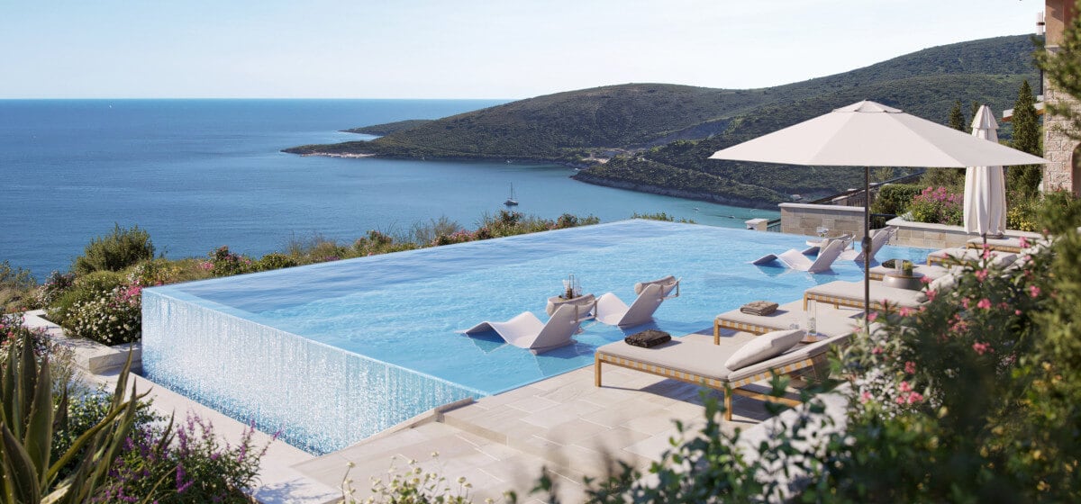 Infinity pool with sea view and sun loungers at the elite residential complex Luštica, Montenegro.