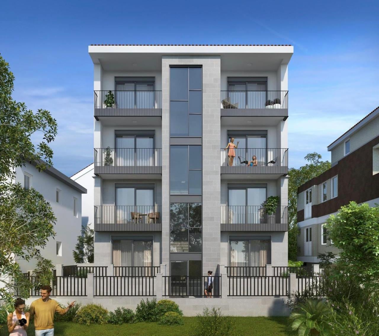 Modern residential complex in Herceg Novi, Montenegro: a four-story building with panoramic glazing and balconies.
