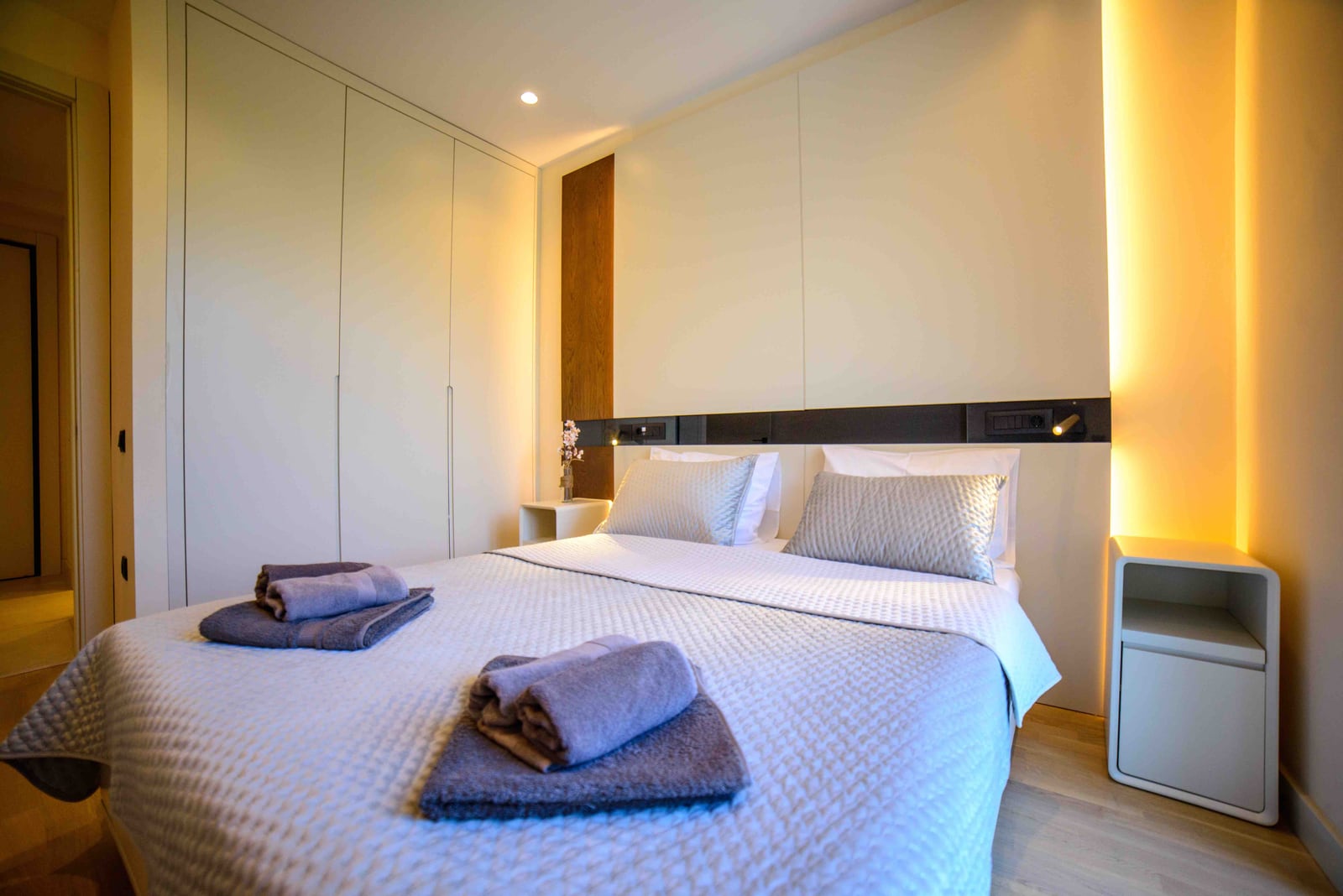 Modern bedroom with a double bed and built-in wardrobe in an apartment, Bečići, Montenegro.