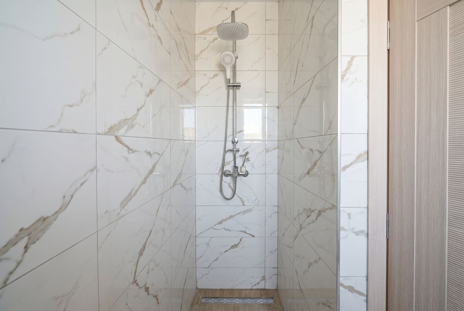 Modern shower cabin with white marble finish in an apartment, Herceg Novi, Montenegro.