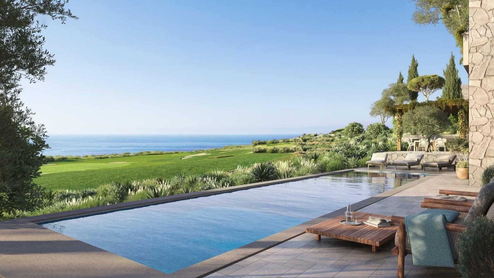 Infinity pool at a villa in Luštica, Montenegro, with panoramic sea views, a golf course, and a terrace with sun loungers.