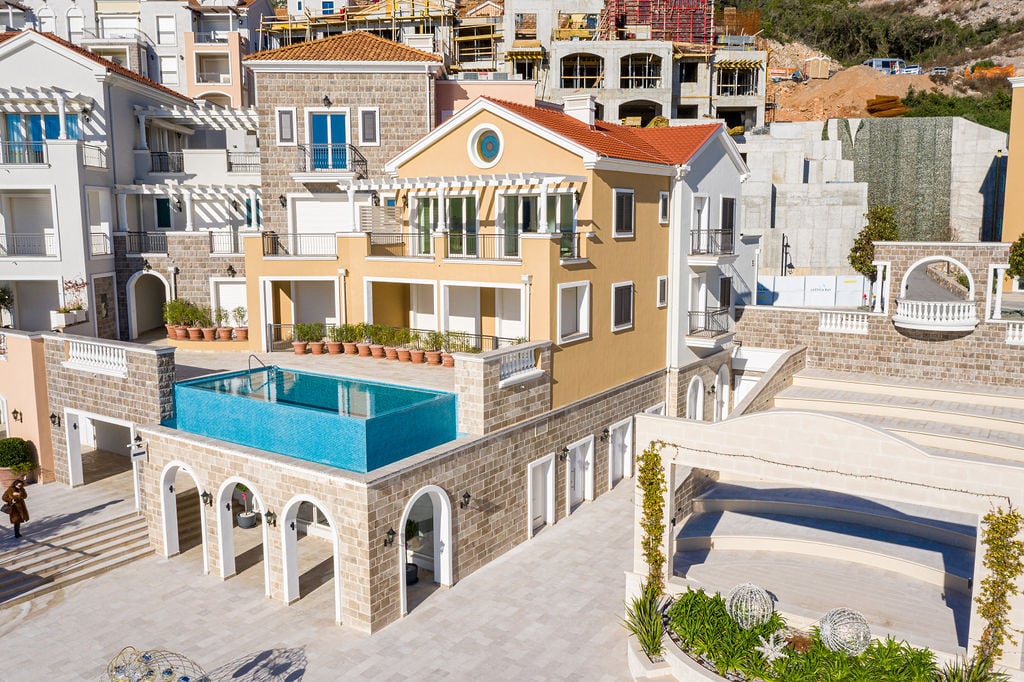 Luxury villa with a pool and stone finishing in the Luštica residential complex, Montenegro: exterior view of the building facade.