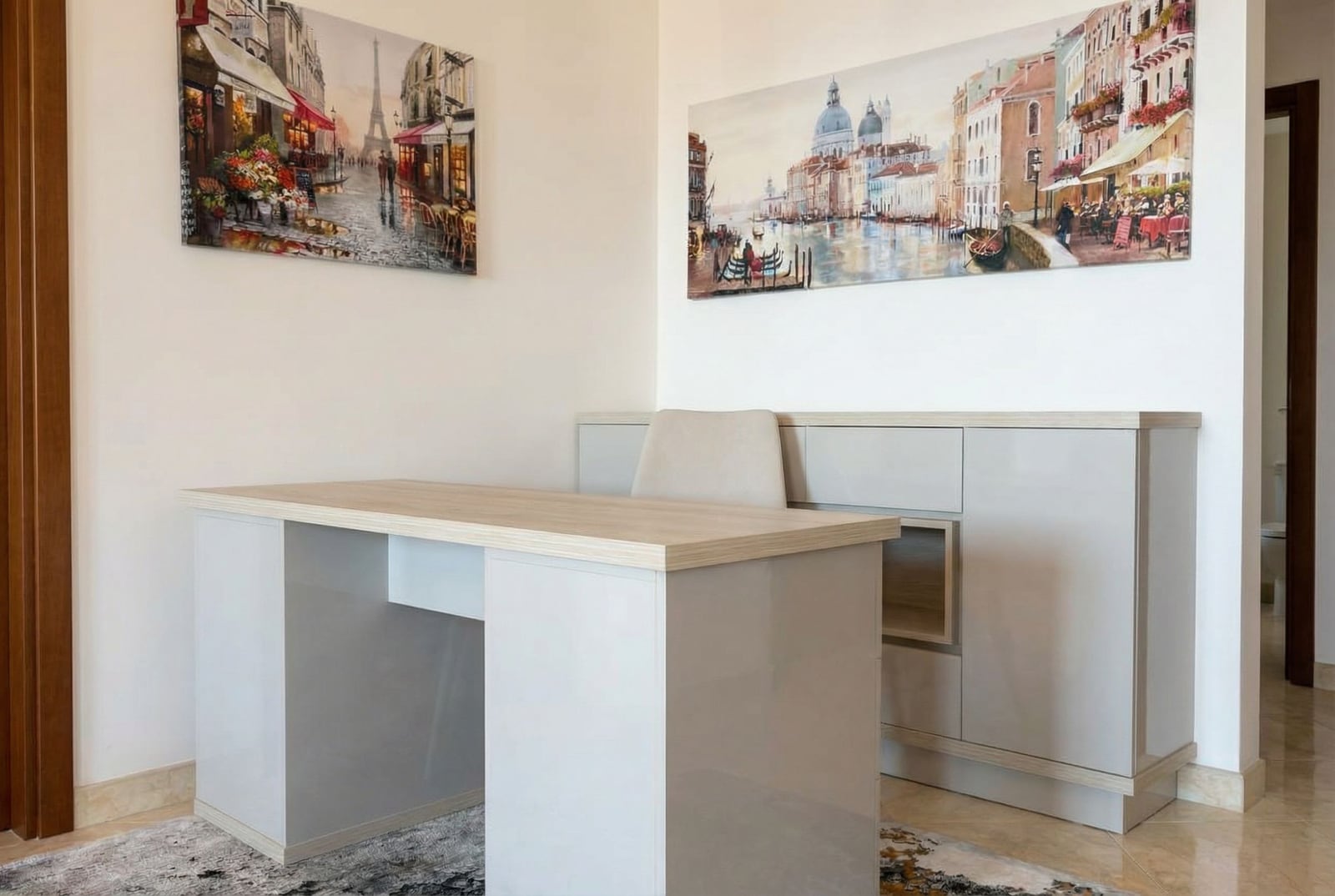 Workspace with a modern desk in an apartment in Rafailovici, Montenegro: light furniture and wall decor.