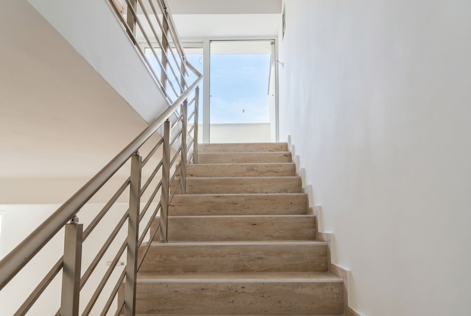 Staircase with stone steps and metal railings in an apartment, Đenovići, Montenegro.