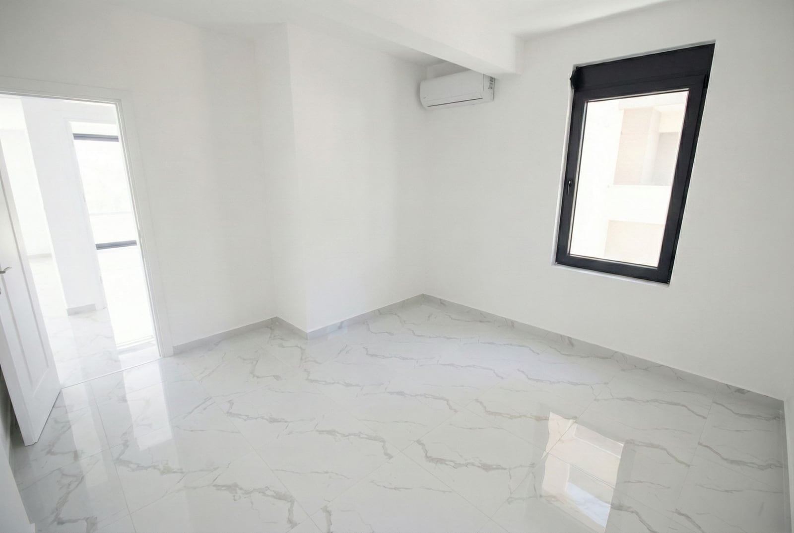 Bright bedroom with marble floor and air conditioning in a new apartment in Kumbor, Herceg Novi, Montenegro.