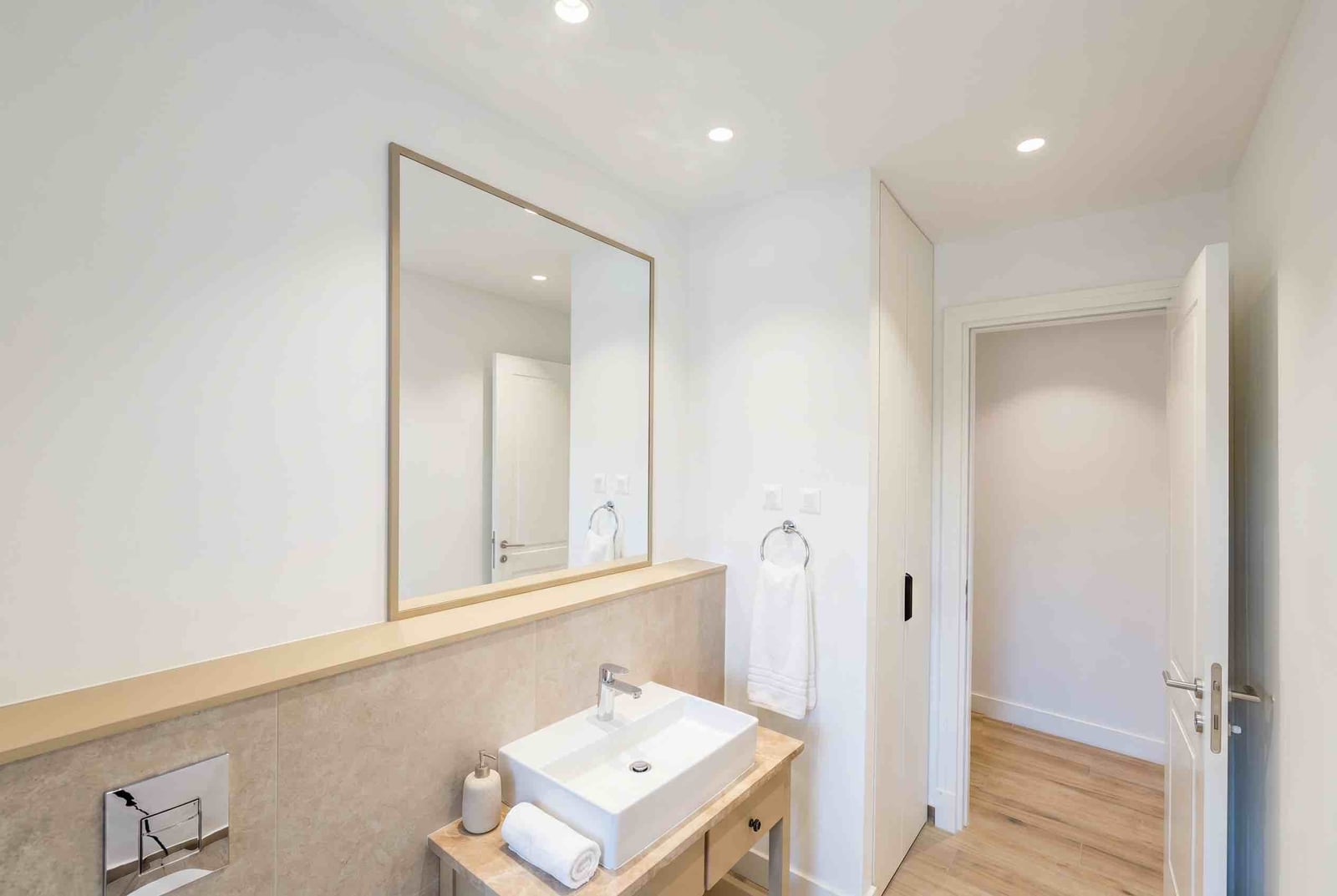 Modern bathroom with a white sink and mirror in an apartment at Luštica Bay, Montenegro.