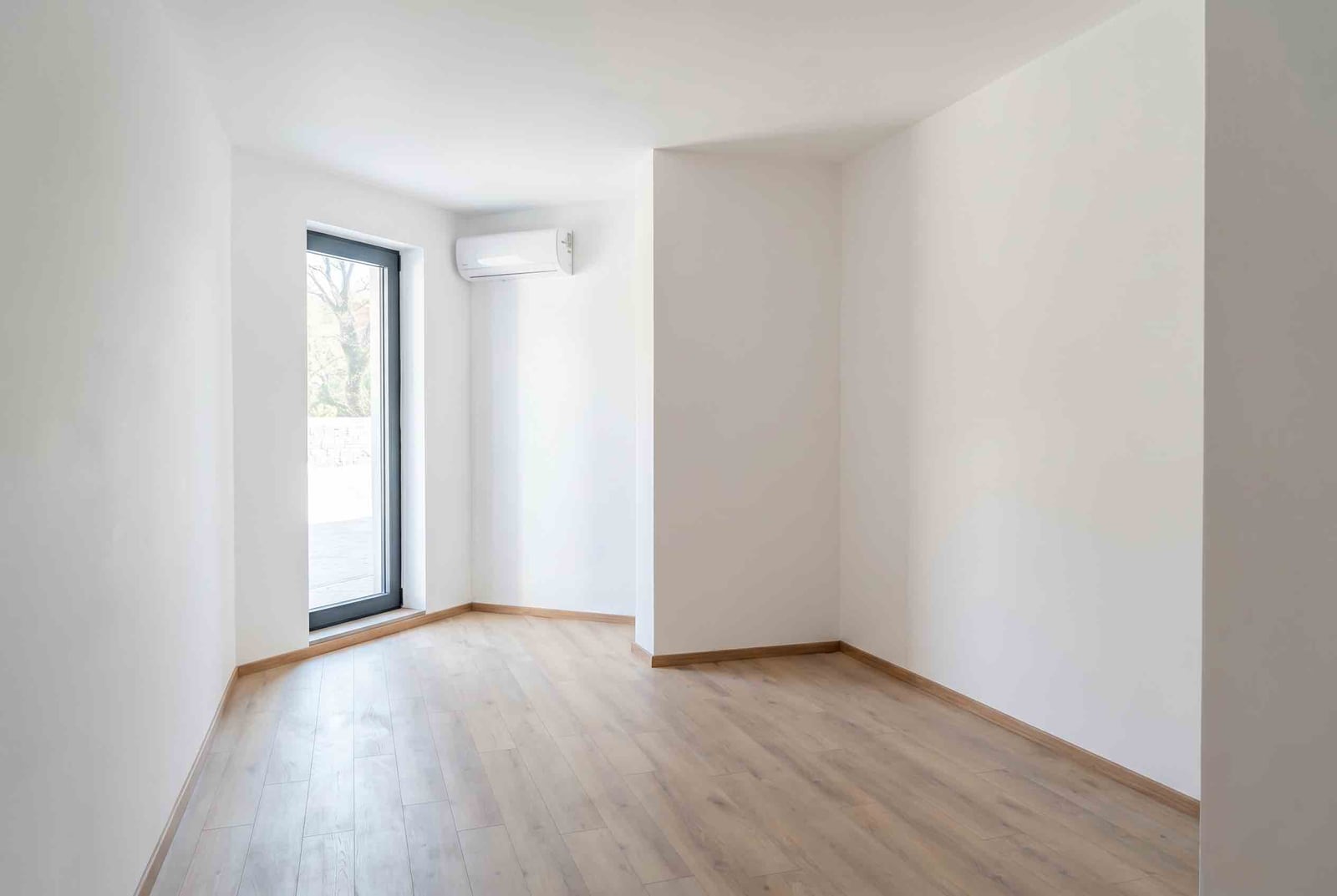 Bright living room with laminate flooring, panoramic window, and air conditioning in an apartment, Pržno, Montenegro.