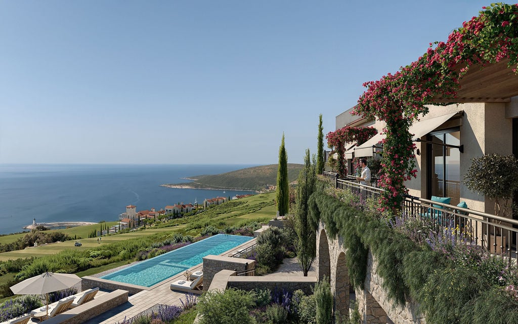 Townhouse terrace with a pool and panoramic sea view in Luštica, Montenegro, surrounded by blooming plants.