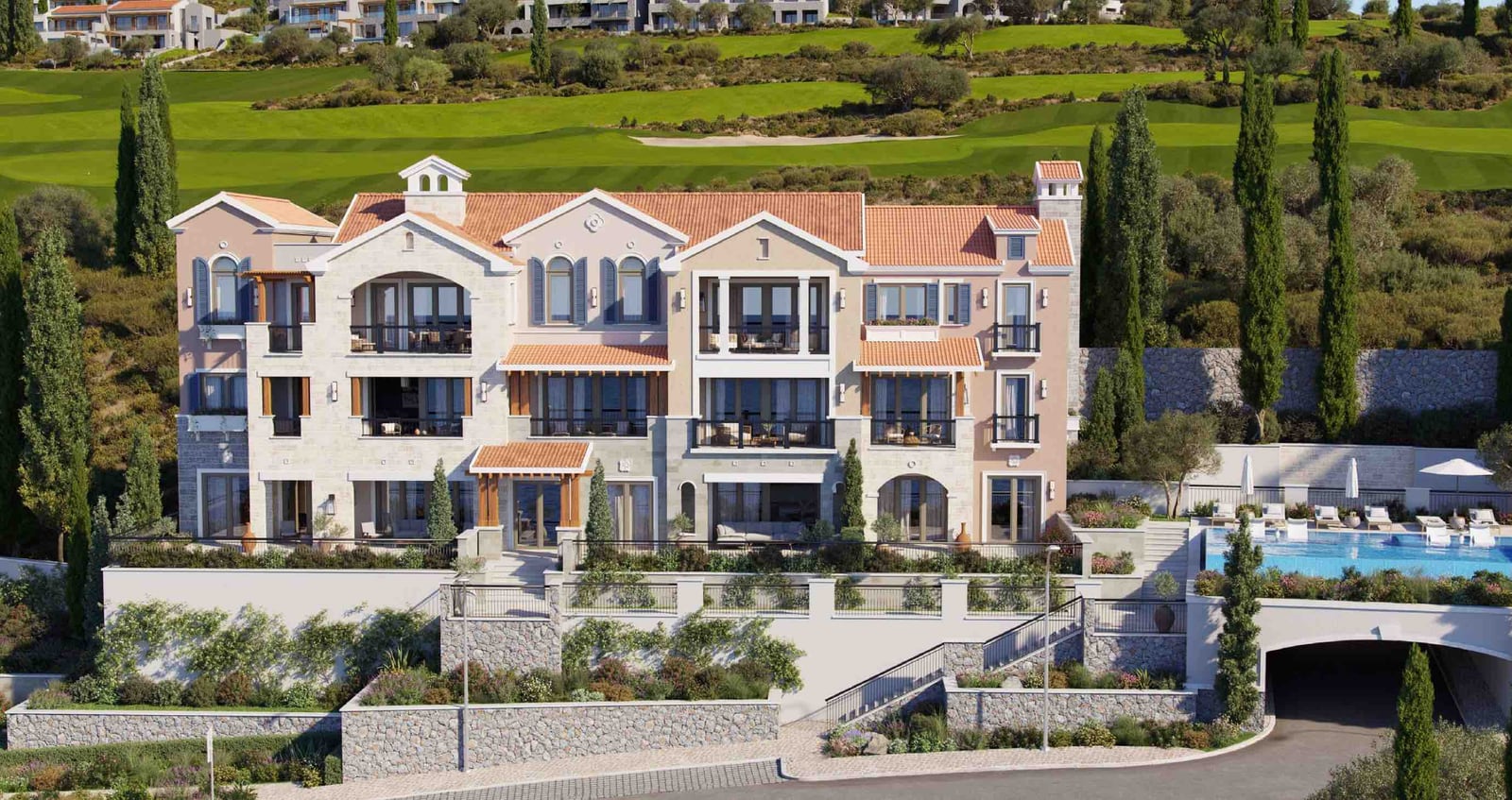 Elite residential complex in Luštica, Montenegro: building facade with terraces, panoramic windows, and an outdoor swimming pool.