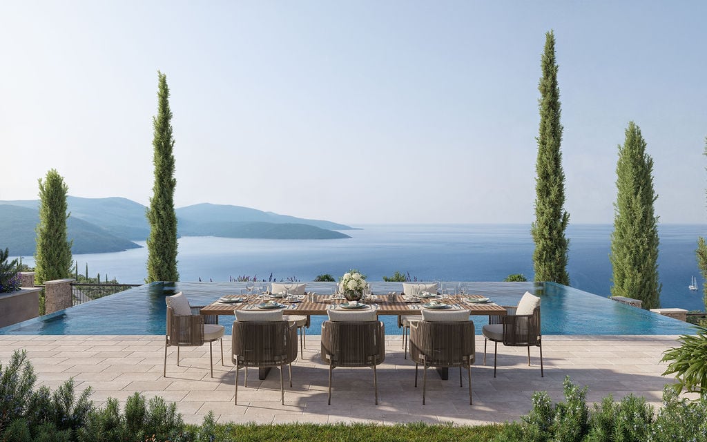 Terrace with a dining area and panoramic pool overlooking the sea in Luštica, Montenegro.