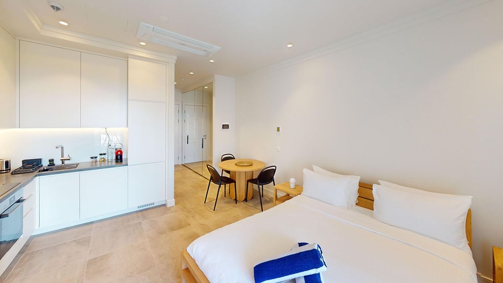 Modern studio with kitchen and bed in Lustica Bay apartments, Luštica, Montenegro: stylish interior and furniture.