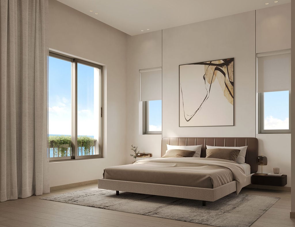Modern bedroom in the Luštica residential complex, Montenegro: double bed, panoramic windows with sea view, and stylish interior.