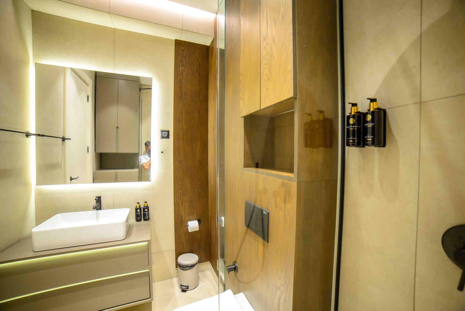 Modern bathroom with wood finish and mirror lighting in an apartment, Bečići, Montenegro.