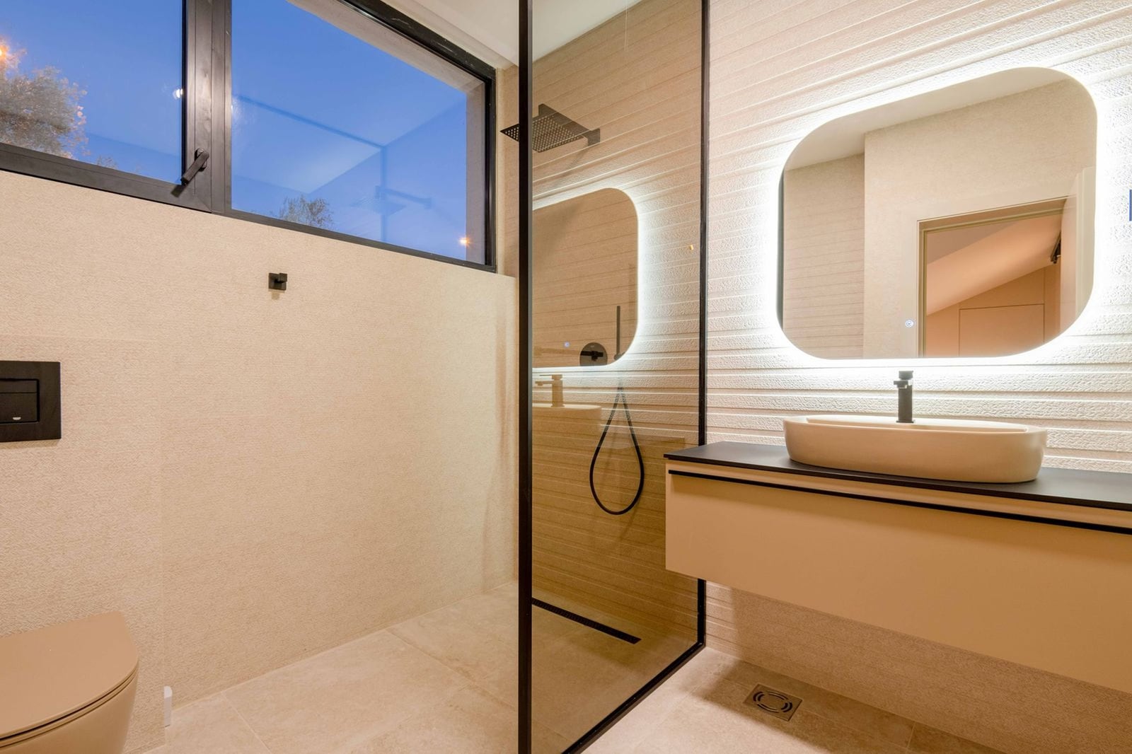 Salle de bains moderne avec cabine de douche et éclairage du miroir dans une villa à Kamenovo, Monténégro.