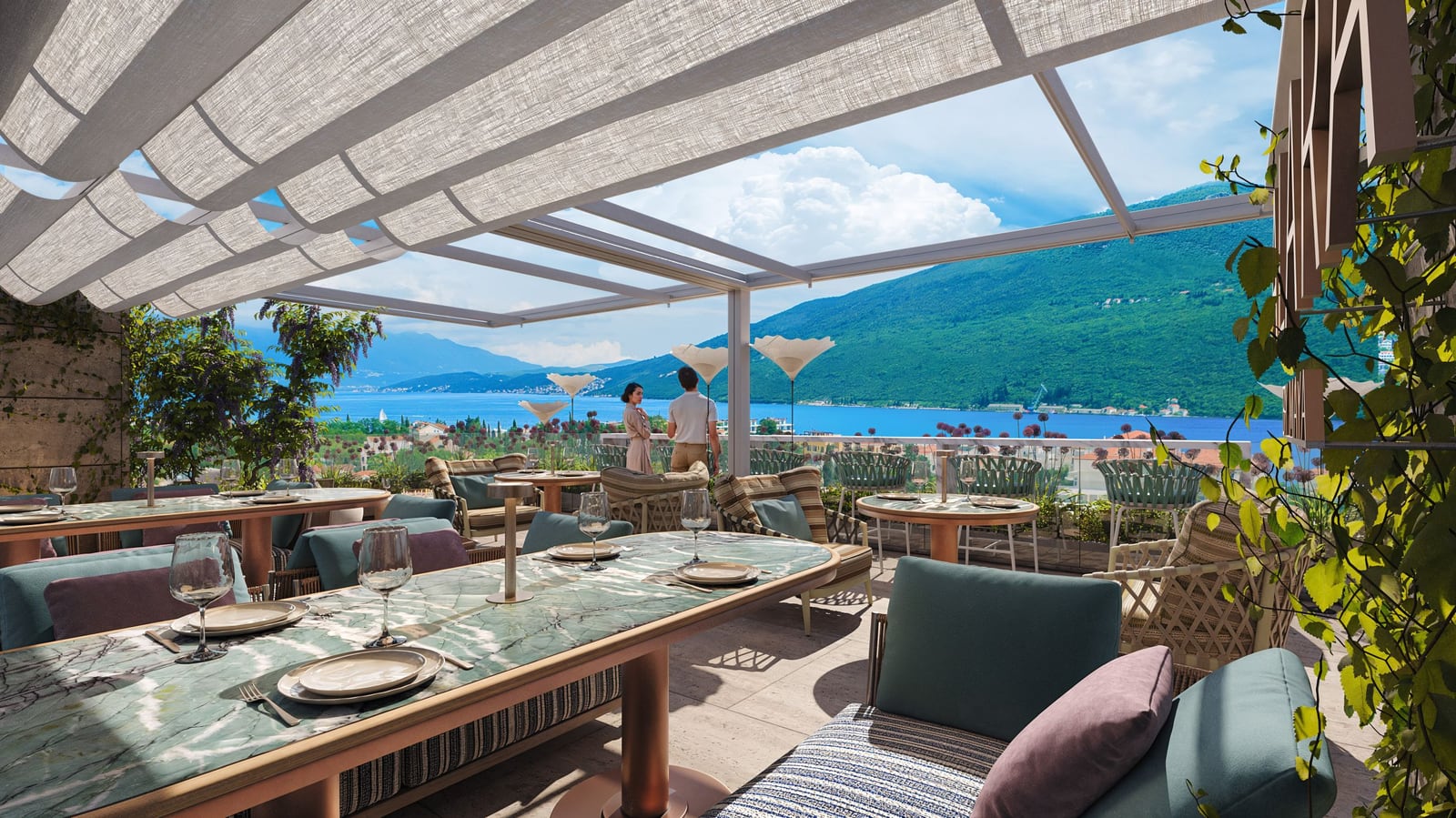 Restaurant terrace in the Kumbor residential complex, Montenegro: tables with marble tabletops, sea and mountain views, sunshade.