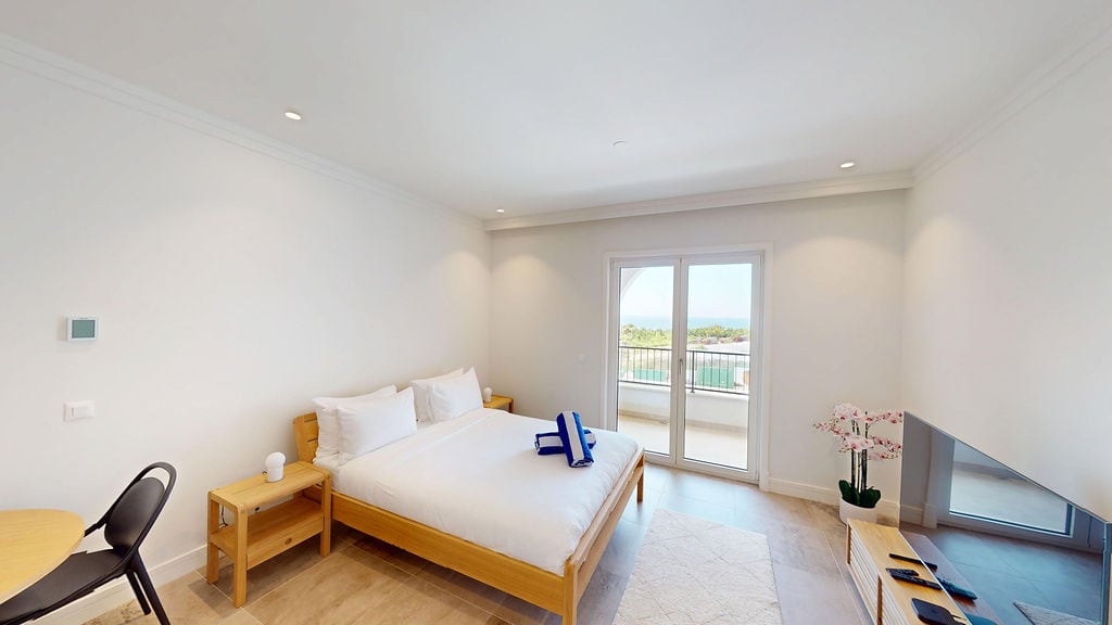 Bright bedroom with a double bed and sea view in an apartment, Luštica, Montenegro. Modern interior.