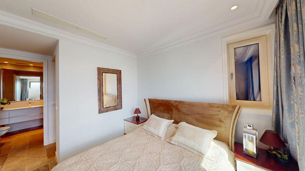 Cozy bedroom with a double bed and bathroom in an apartment, Luštica, Montenegro. Modern interior.