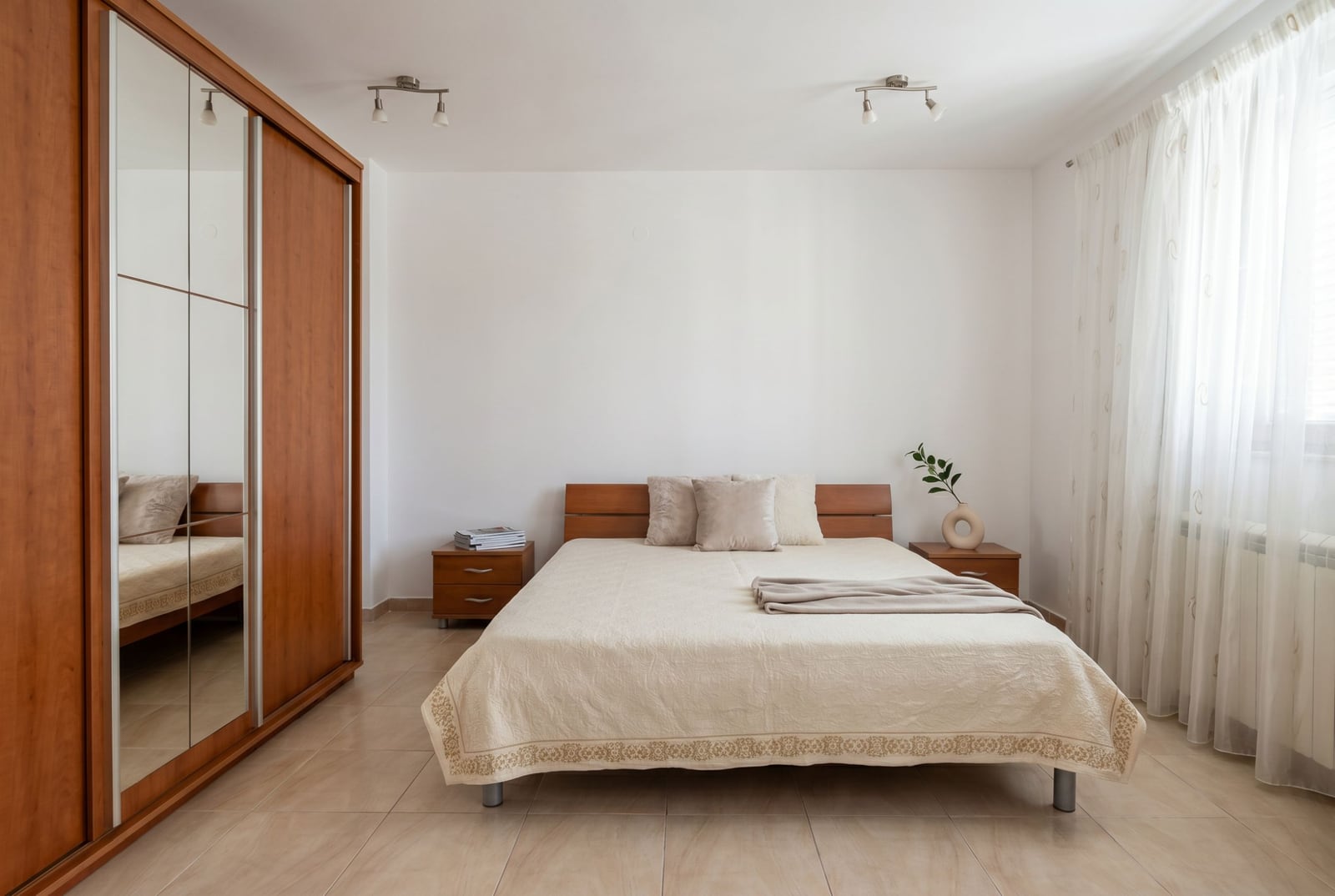 Bright bedroom with a double bed and a built-in wardrobe in a house for sale, Baošići, Montenegro.
