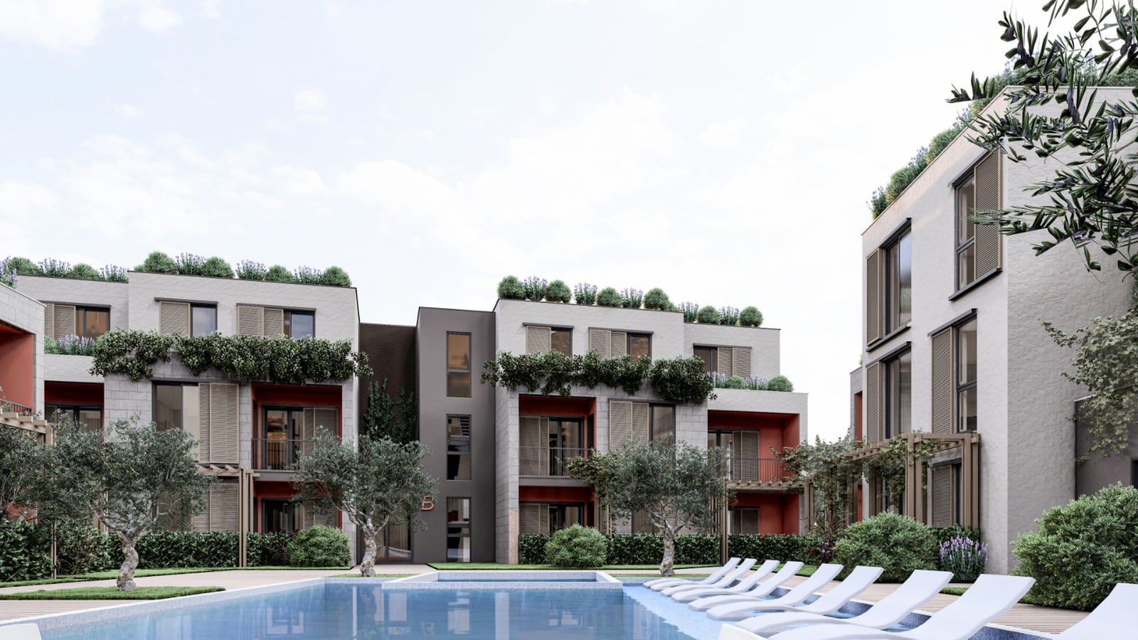 Modern residential complex with a pool and relaxation area in Radanovici, Montenegro: view of the building facades with landscaping.