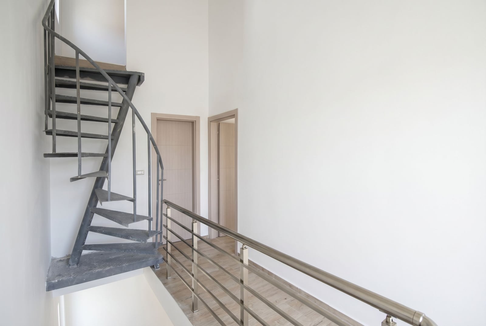Spiral staircase and bright hallway in an apartment, Đenovići, Herceg Novi, Montenegro: modern finishes and railings.