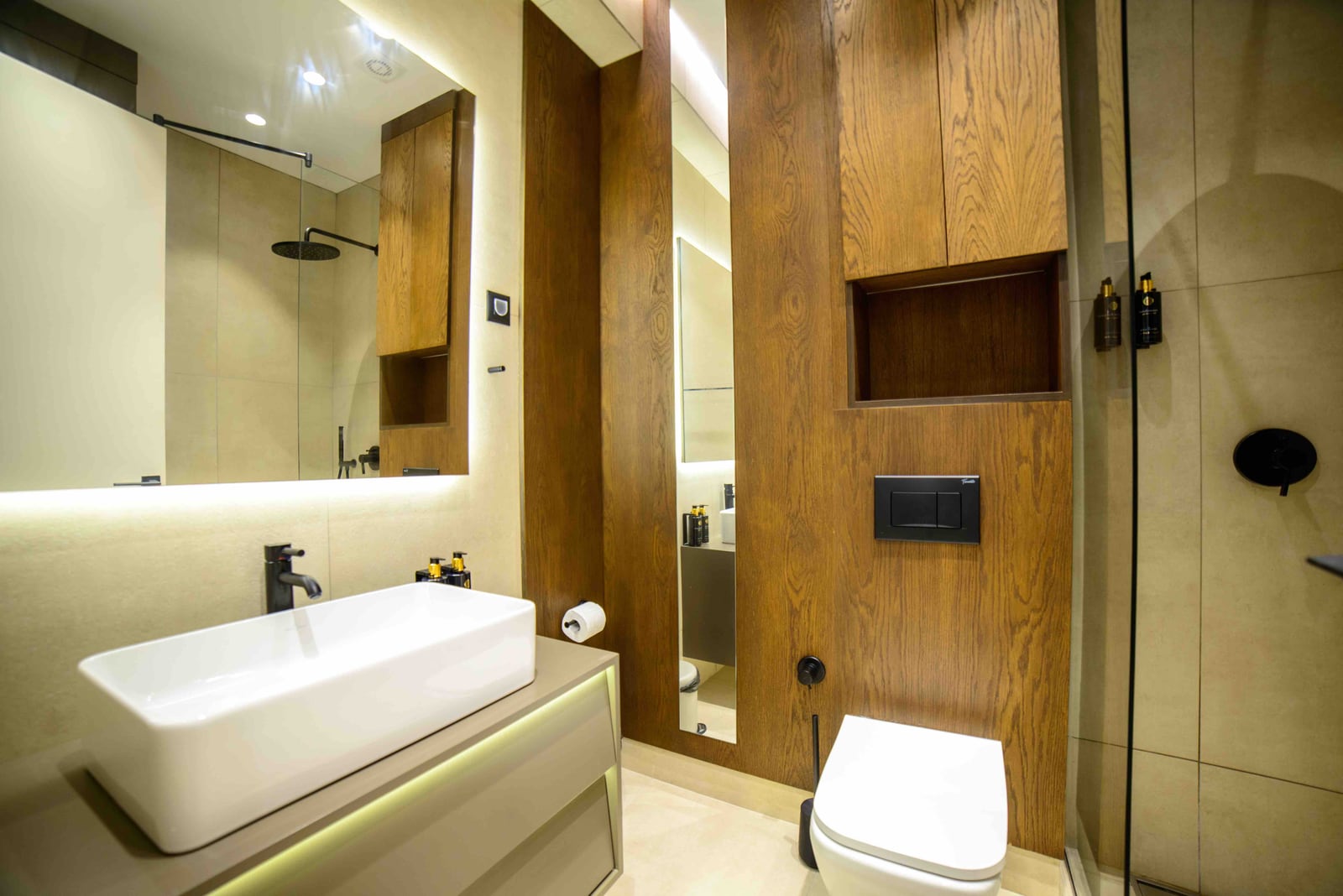 Modern bathroom with wood finish and shower cabin in an apartment in Bečići, Montenegro.