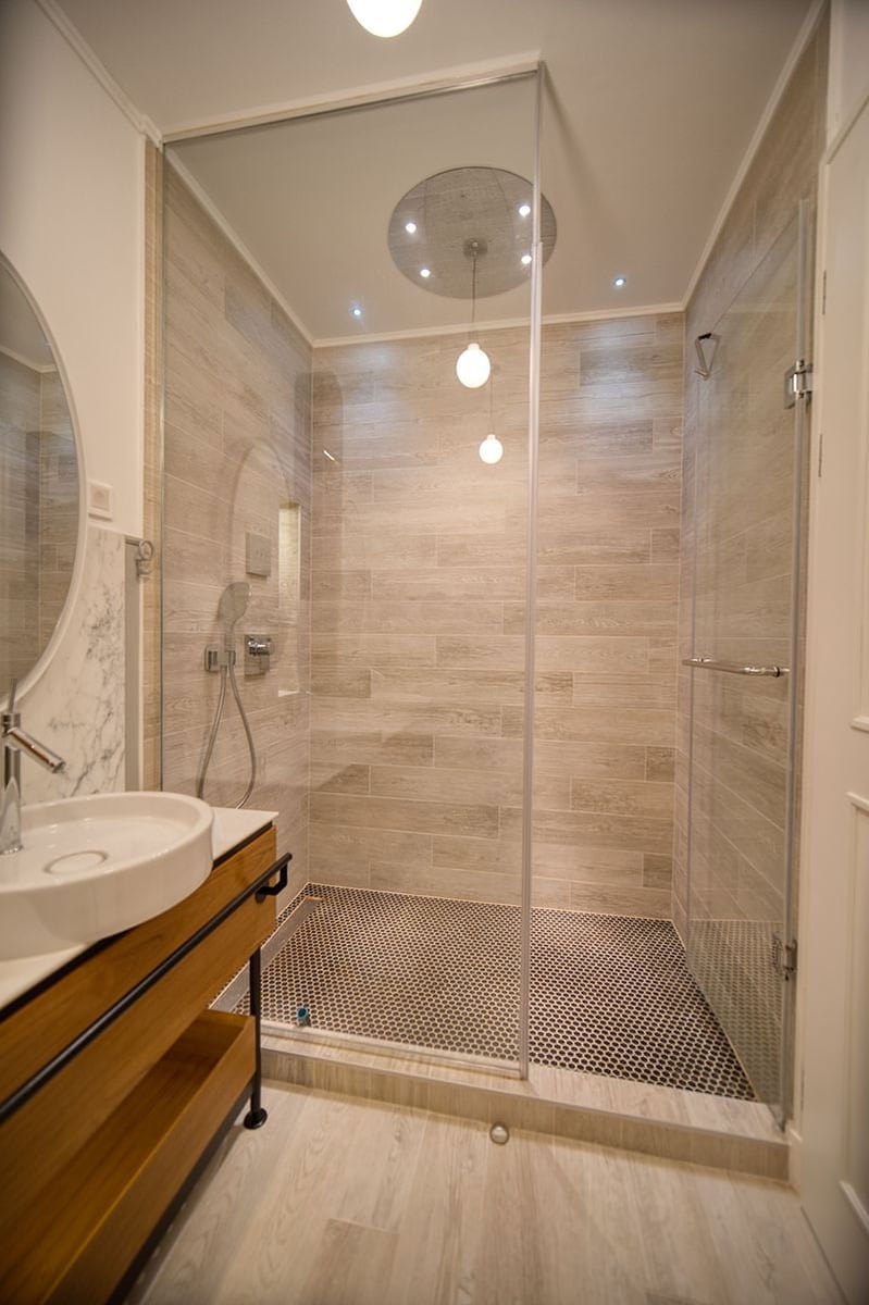 Modern bathroom in an apartment, Luštica, Montenegro: shower cabin, wood-like finish, and stylish sanitary ware.