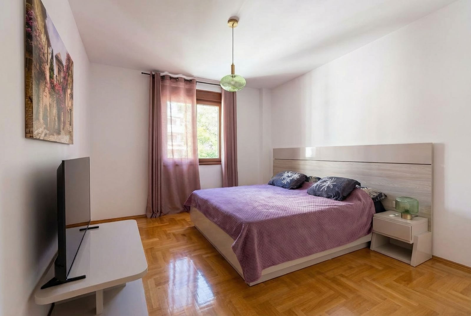 Cozy bedroom with a double bed and parquet flooring in an apartment, Rafailovići, Montenegro.