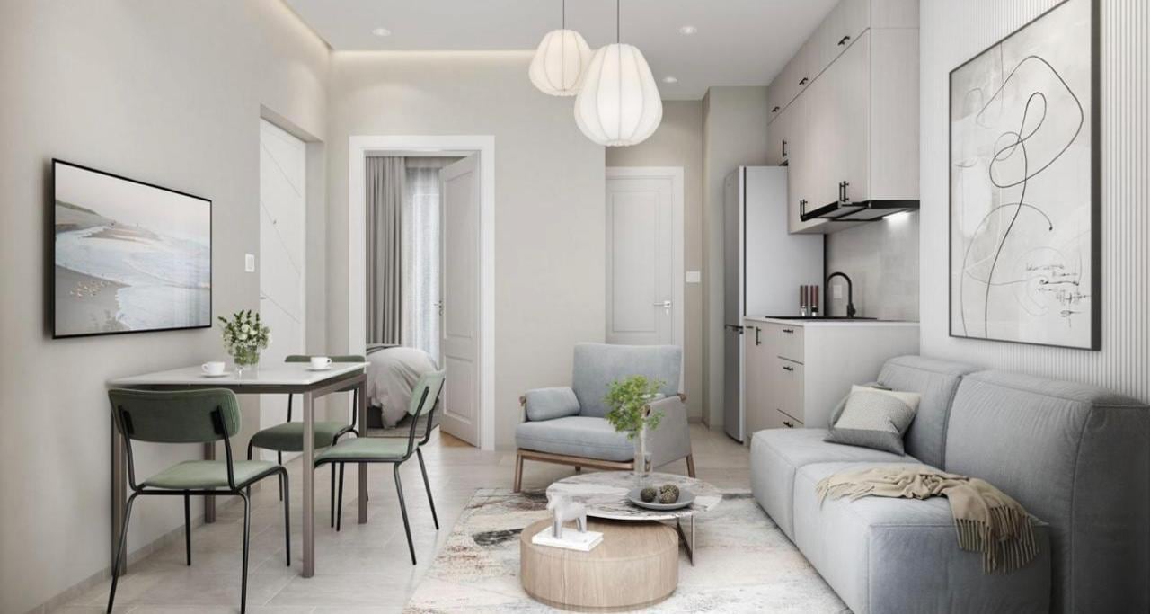 Modern living room with kitchen in Herceg Novi residential complex, Montenegro: bright interior, soft furniture, and dining area.