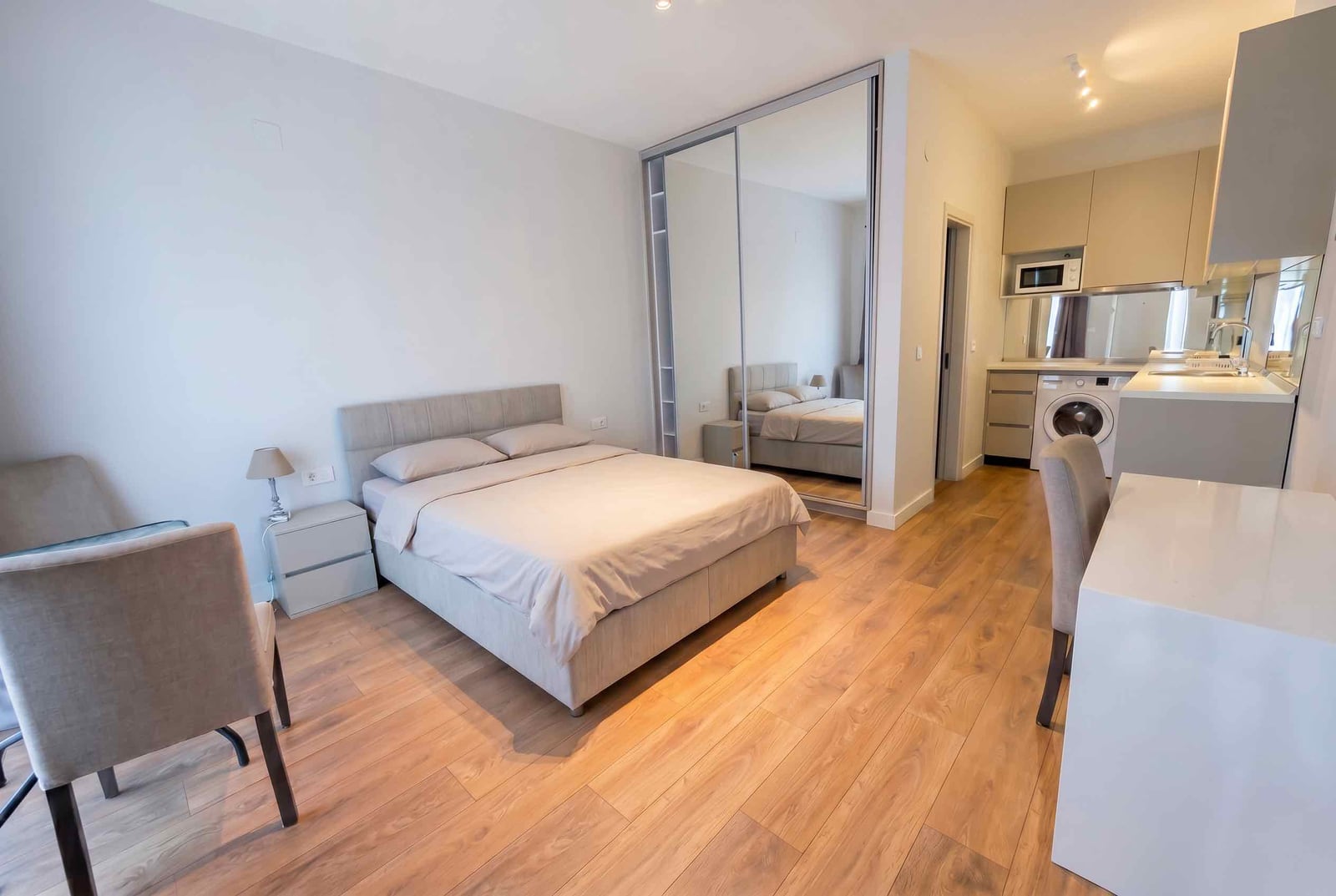 Modern bedroom with a double bed and built-in kitchen in an apartment, Kavač, Montenegro.