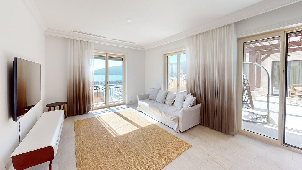 Bright living room with access to a terrace and sea view in a luxury apartment, Luštica, Montenegro.