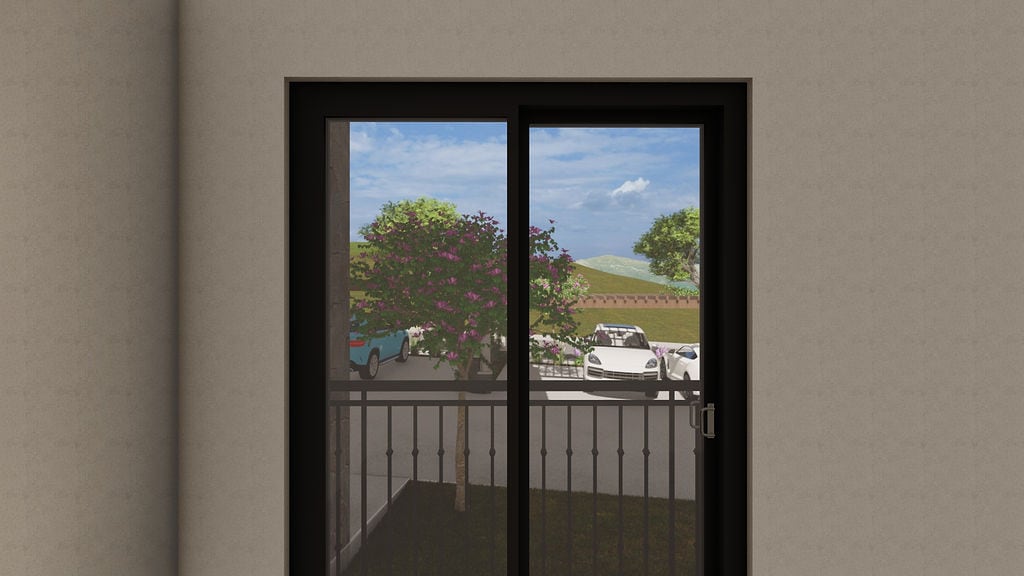 View from the balcony of an apartment in Luštica, Montenegro: panoramic glazing, wrought iron railing, and a parking lot with trees.