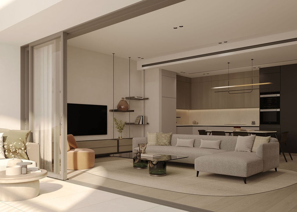 Modern living room with kitchen in an apartment at Luštica Bay, Montenegro: gray sofa, panoramic windows, and stylish interior.