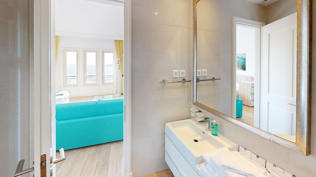 Modern bathroom with white furniture and a view of the living room in an apartment, Krašići, Montenegro.